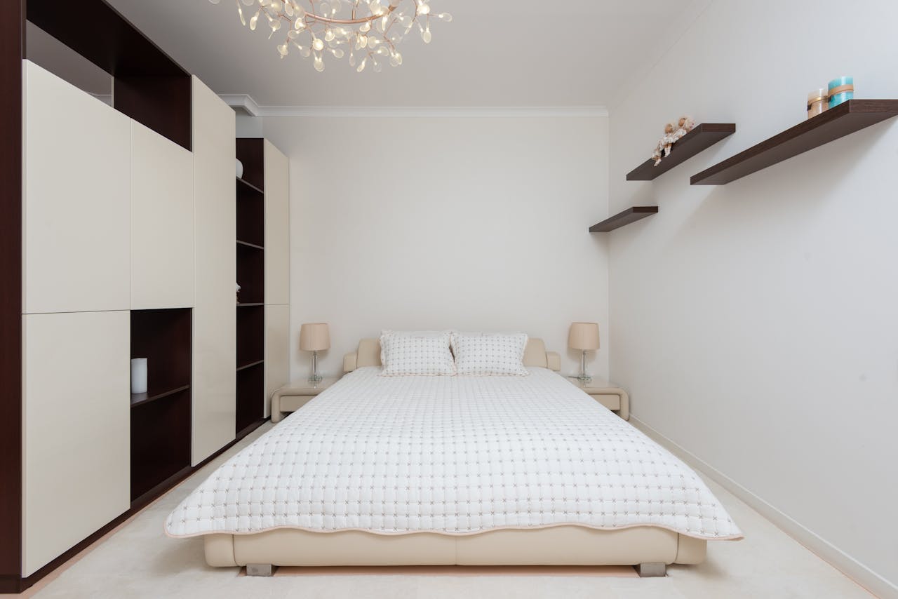 services-02 Interior of contemporary large bedroom with black shelves and bed with soft cushions